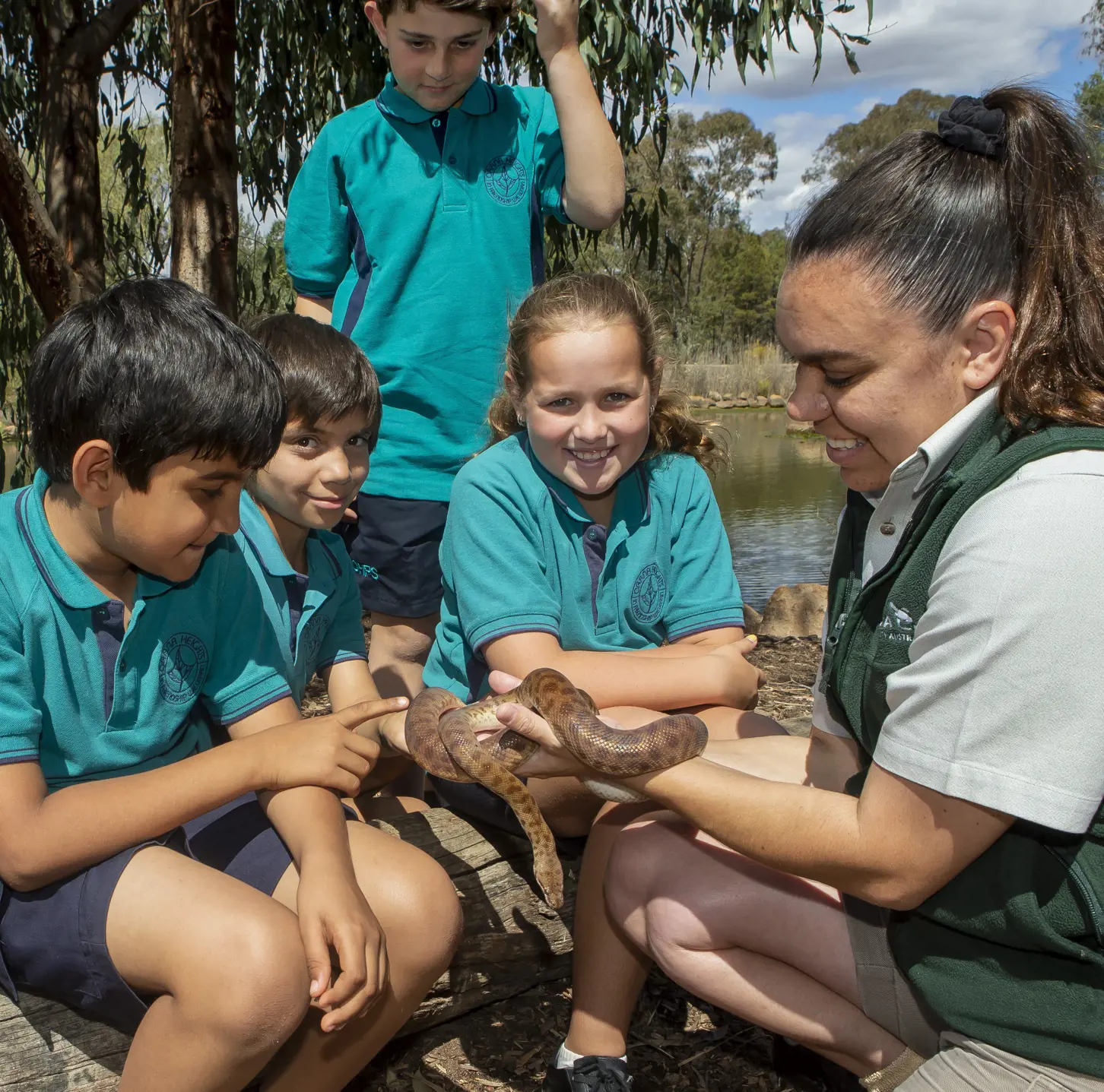 Studens learning about snake with Taronga educator during workshop at Taronga Western Plains Zoo in Dubbo